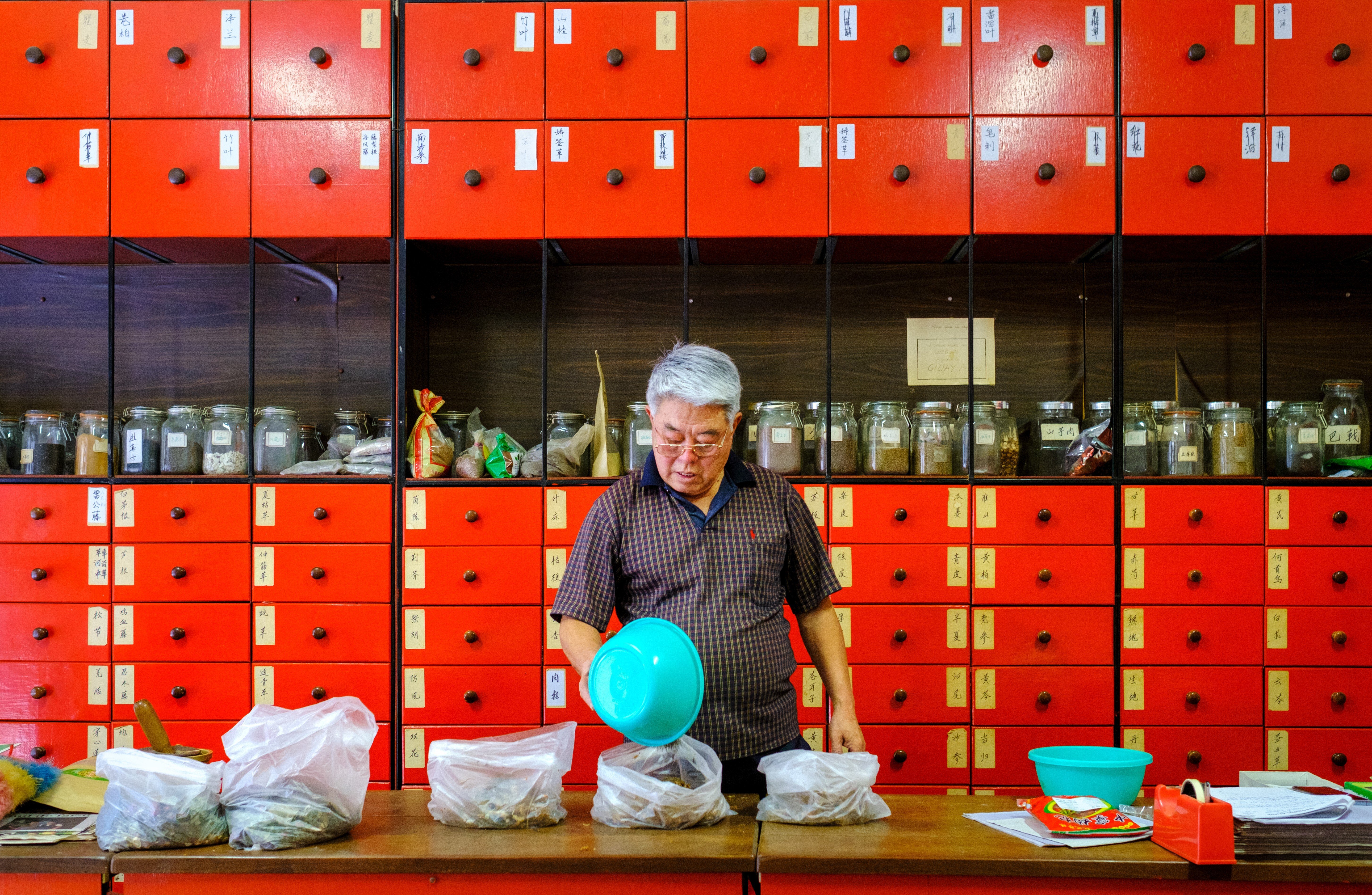 Herbalist Dr Zhang prepares a concoction of Chinese herbs at Hoaping Clinic in Northbridge, Perth, Western Australia. Northbridge is like stepping through a portal into China itself. Photo: Lynn Gail