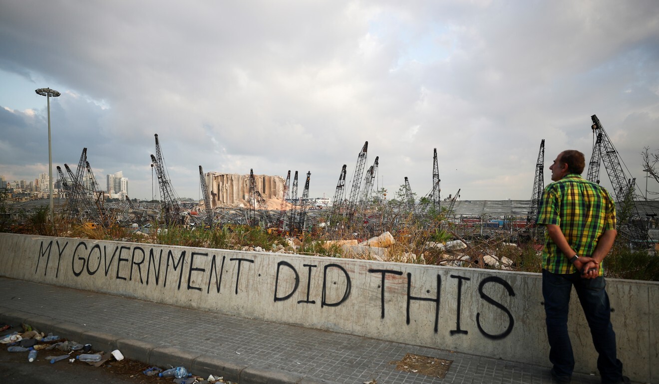 A man looks out at the damaged port area in Beirut. Photo: Reuters