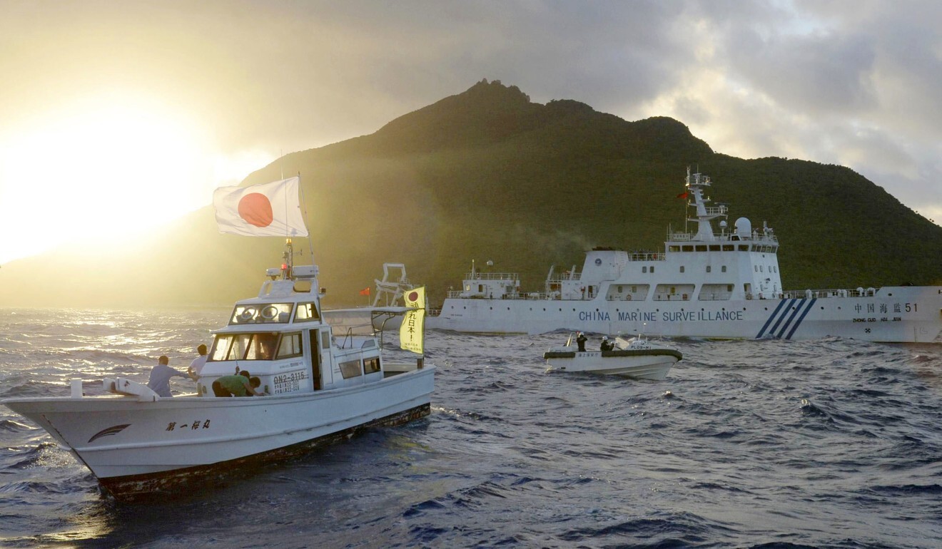 A Chinese maritime surveillance vessel (R) passes the Senkaku (Diaoyu) Islands. Photo: Kyodo