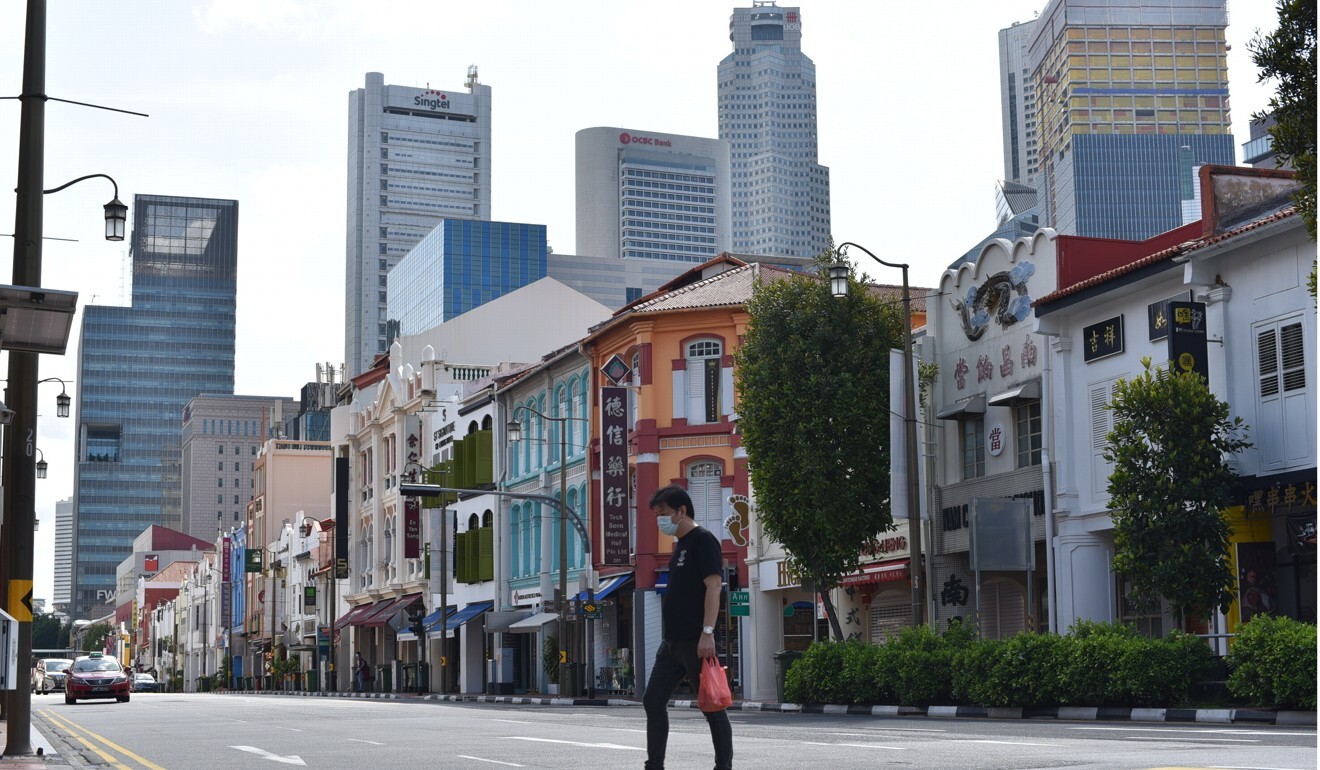 A man crosses the street in Singapore’s Chinatown district. Photo: AP