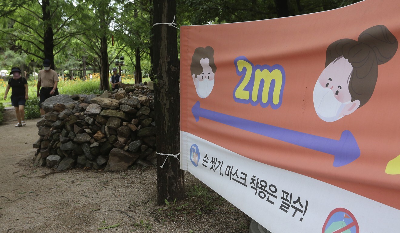 A banner promoting social distancing and urging people to wash their hands and wear a mask is seen at a park in Goyang last month. Photo: AP