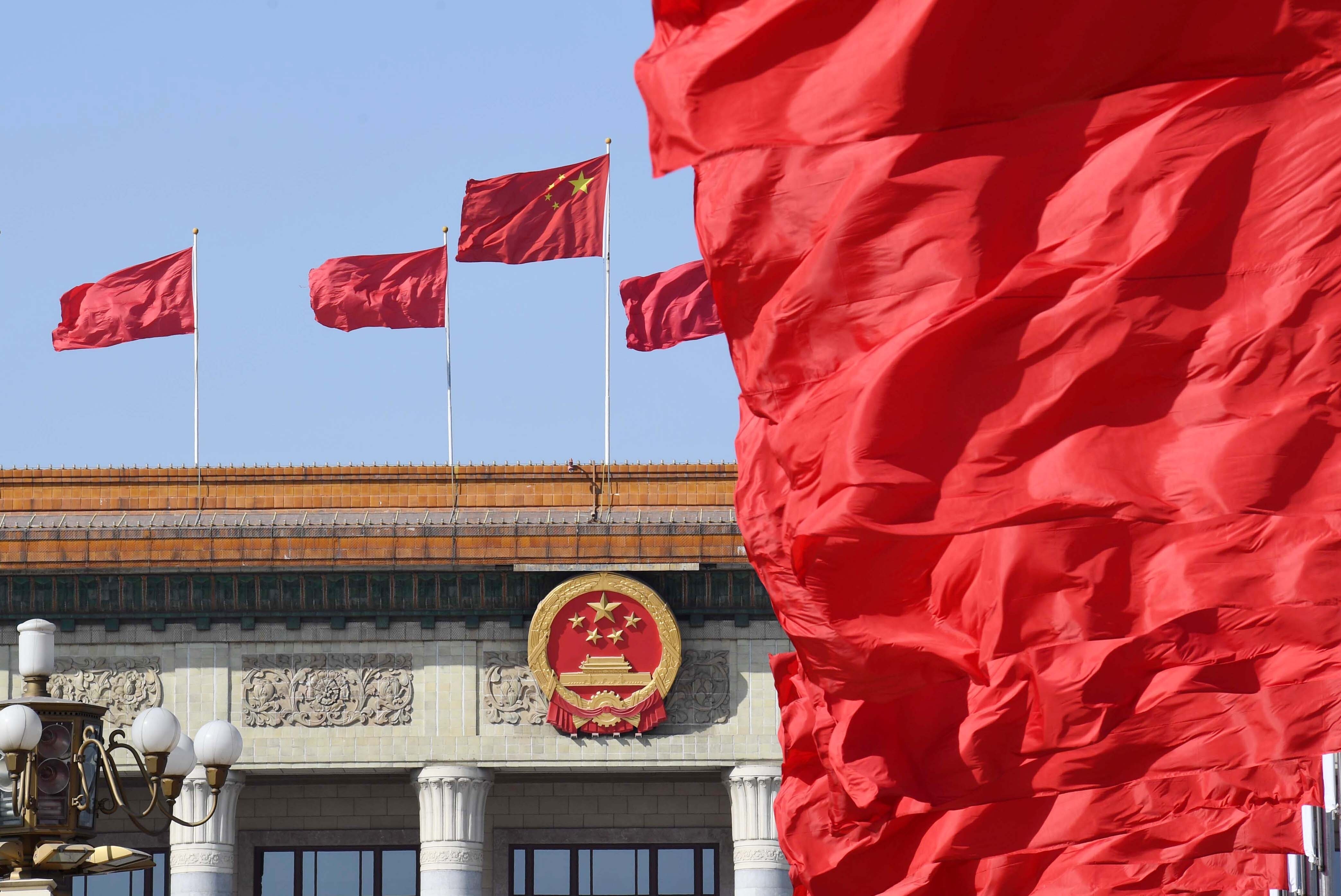 Flags fly atop the Great Hall of the People, where full sessions of the National People’s Congress are held. Photo: Xinhua