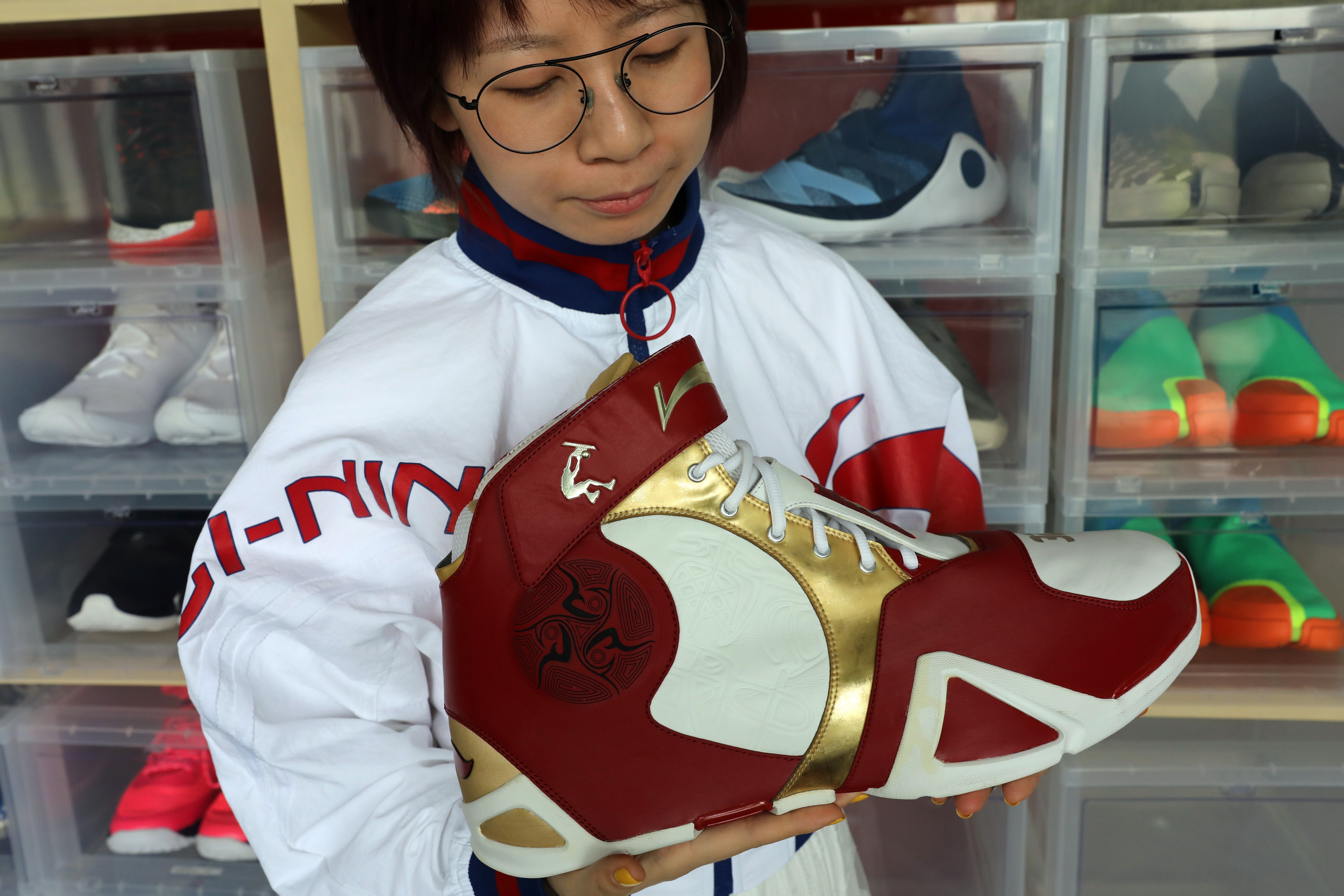 A staff displays a Li Ning shoe tailored made for former NBA star Shaquille O'Neal, in Beijing on April 29, 2019. The Chinese sportswear brand weathered the uncertainty in the first half better than what analysts expected. Photo: Simon Song
