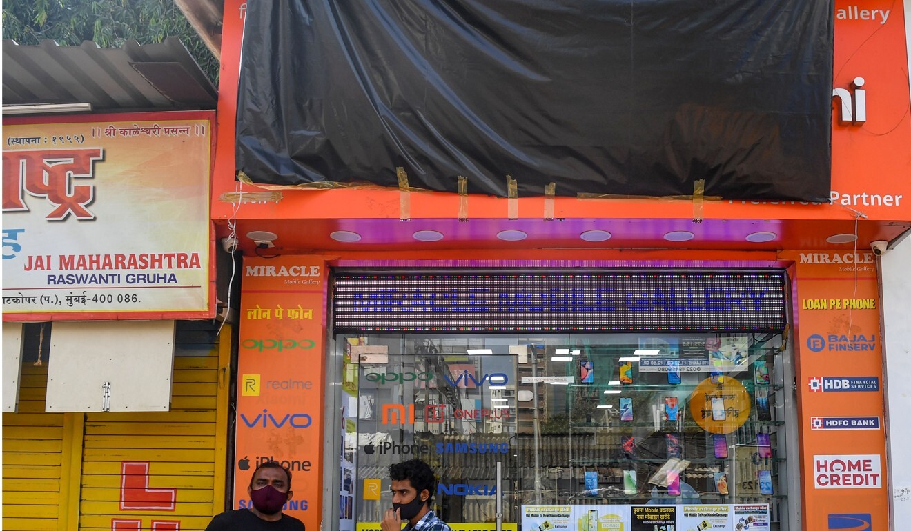 A shop selling Xiaomi mobile phones in Mumbai covers a reference to the Chinese brand on its store front following anger over the border clash. Photo: AFP