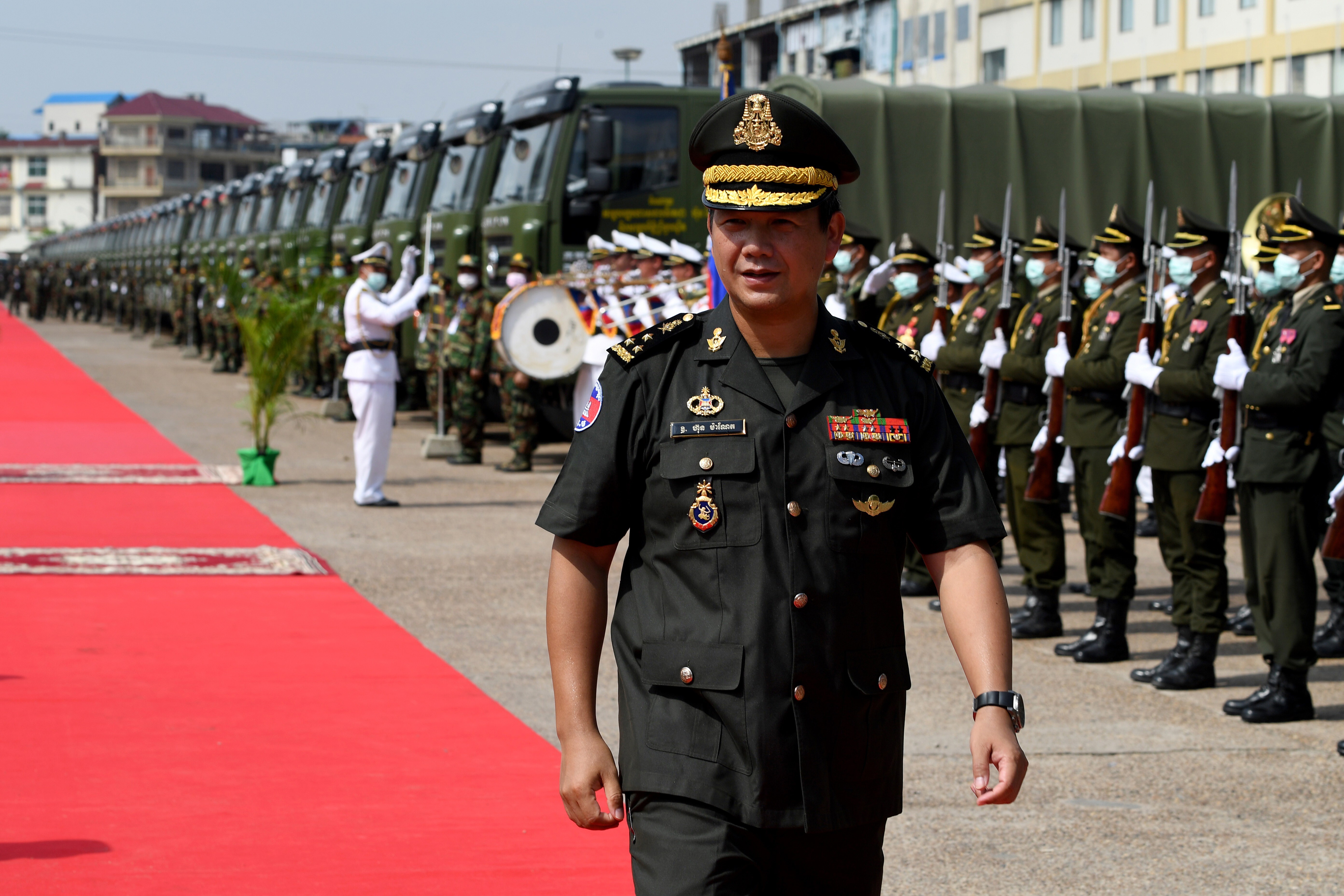Hun Manet passes the honour guard during a ceremony in Phnom Penh to accept 290 Chinese military trucks. Photo: AFP