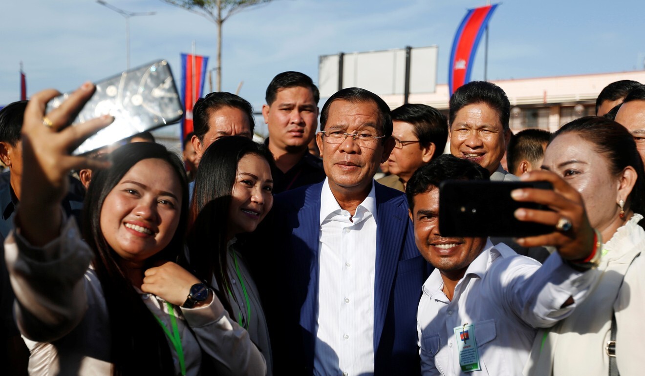 Supporters pose for a picture with Cambodia's Prime Minister Hun Sen in Phnom Penh. Photo: Reuters