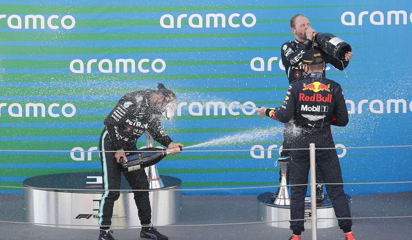 Lewis Hamilton celebrates on the podium with Max Verstappen and Valtteri Bottas. Photo: Reuters