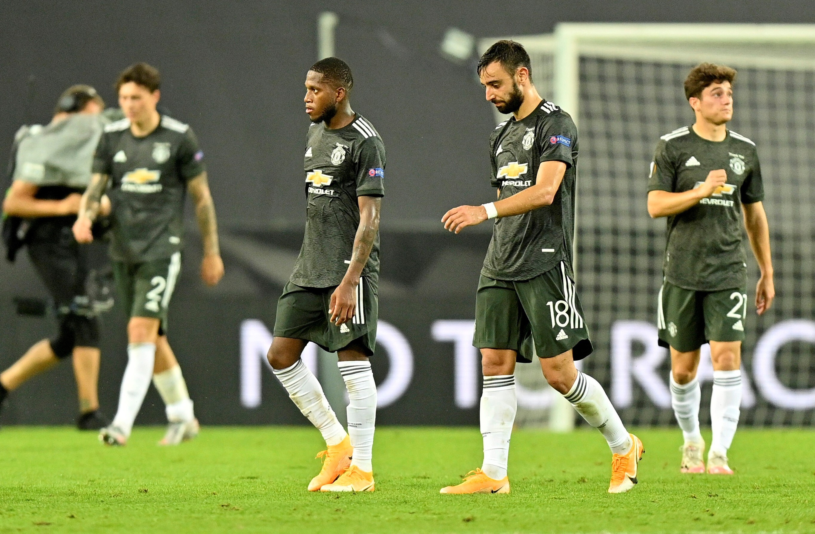 Dejected Manchester players leave the pitch after their Europa League loss to Sevilla. Photo: Reuters