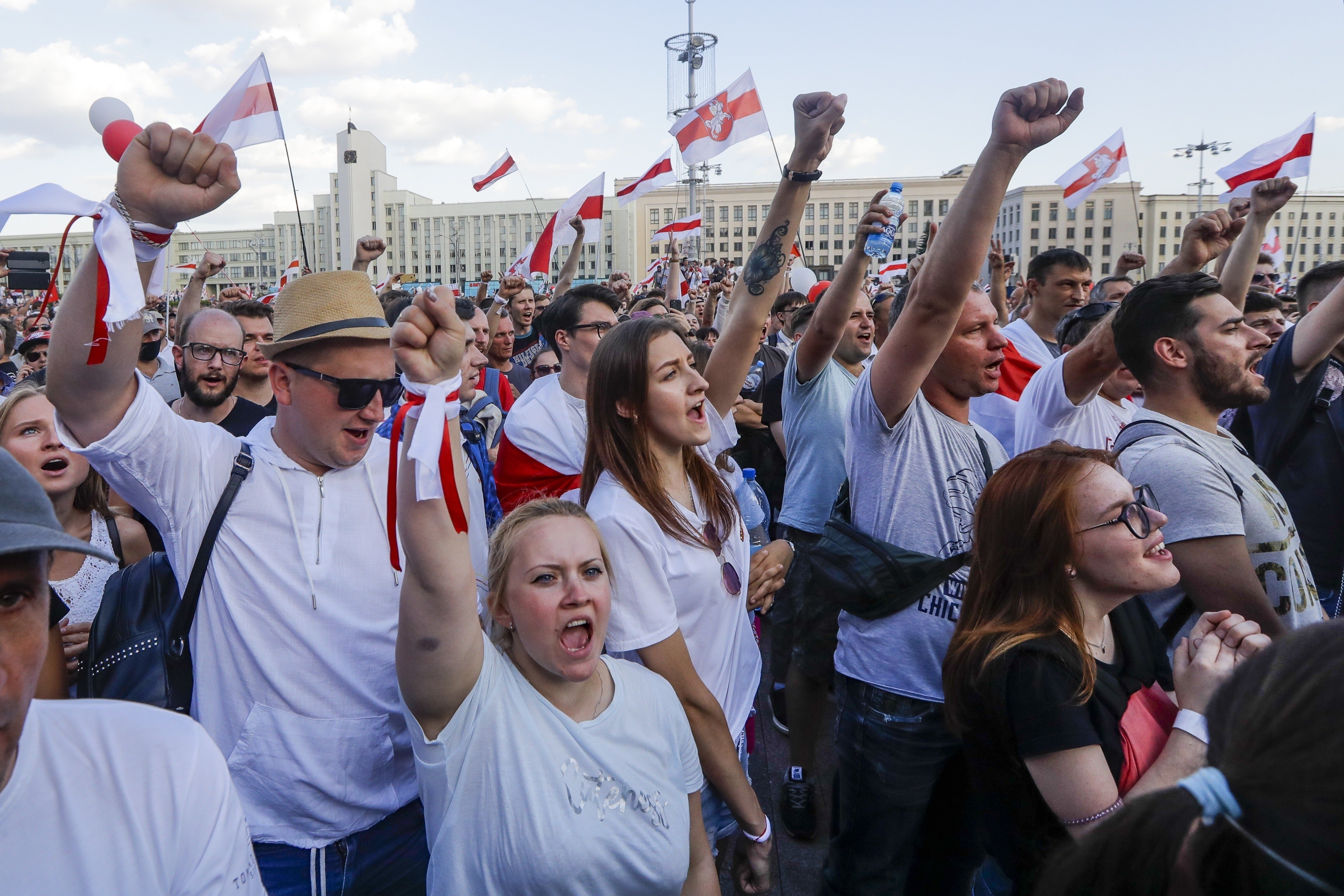 People with old Belarusian national flags rally in Minsk. Photo: AP
