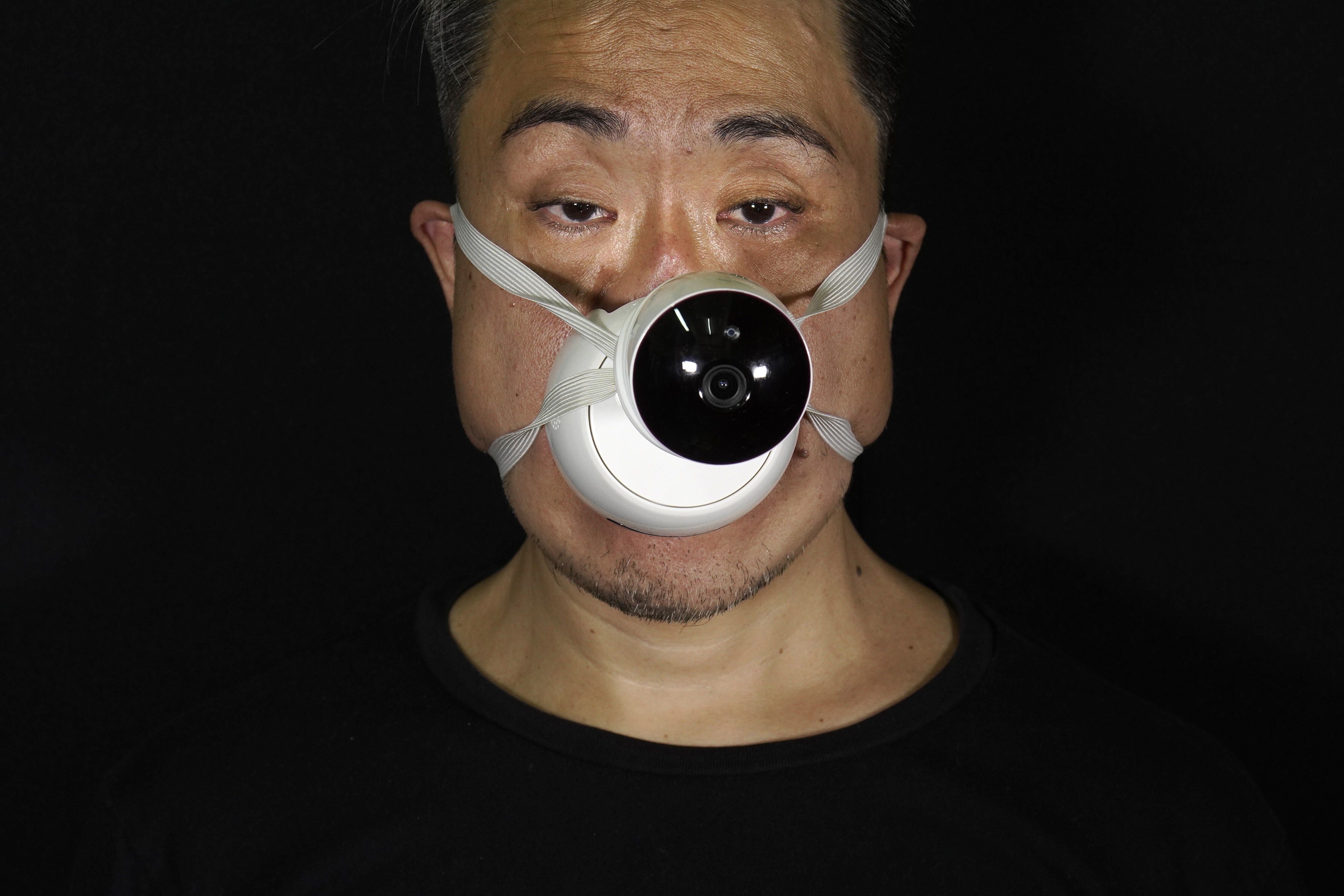 Edmond Kok models one of his face masks, with a design inspired by the now ubiquitous CCTV camera, a tool of public security and control. Photo: AP