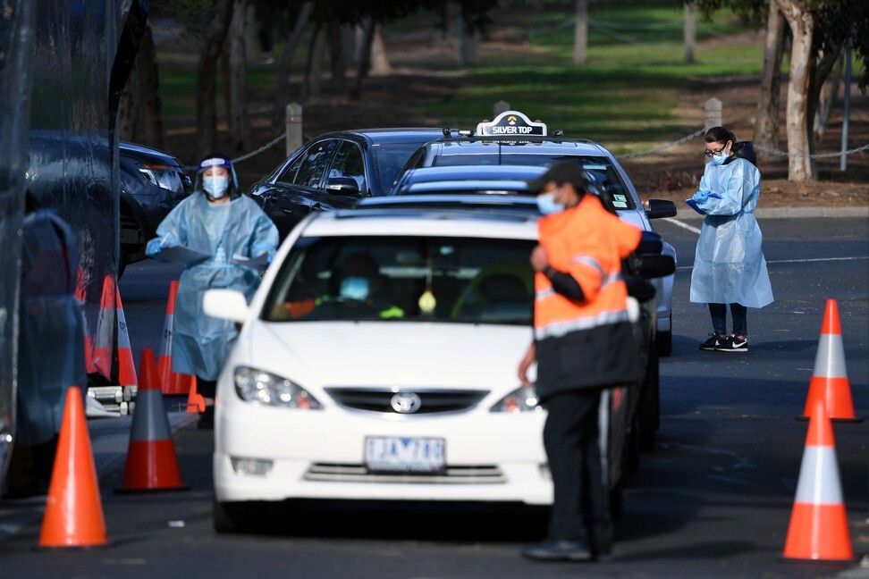 Health care workers carry out Covid-19 tests at a drive-through testing facility in Melbourne on August 18, 2020. Photo: AAP via Reuters