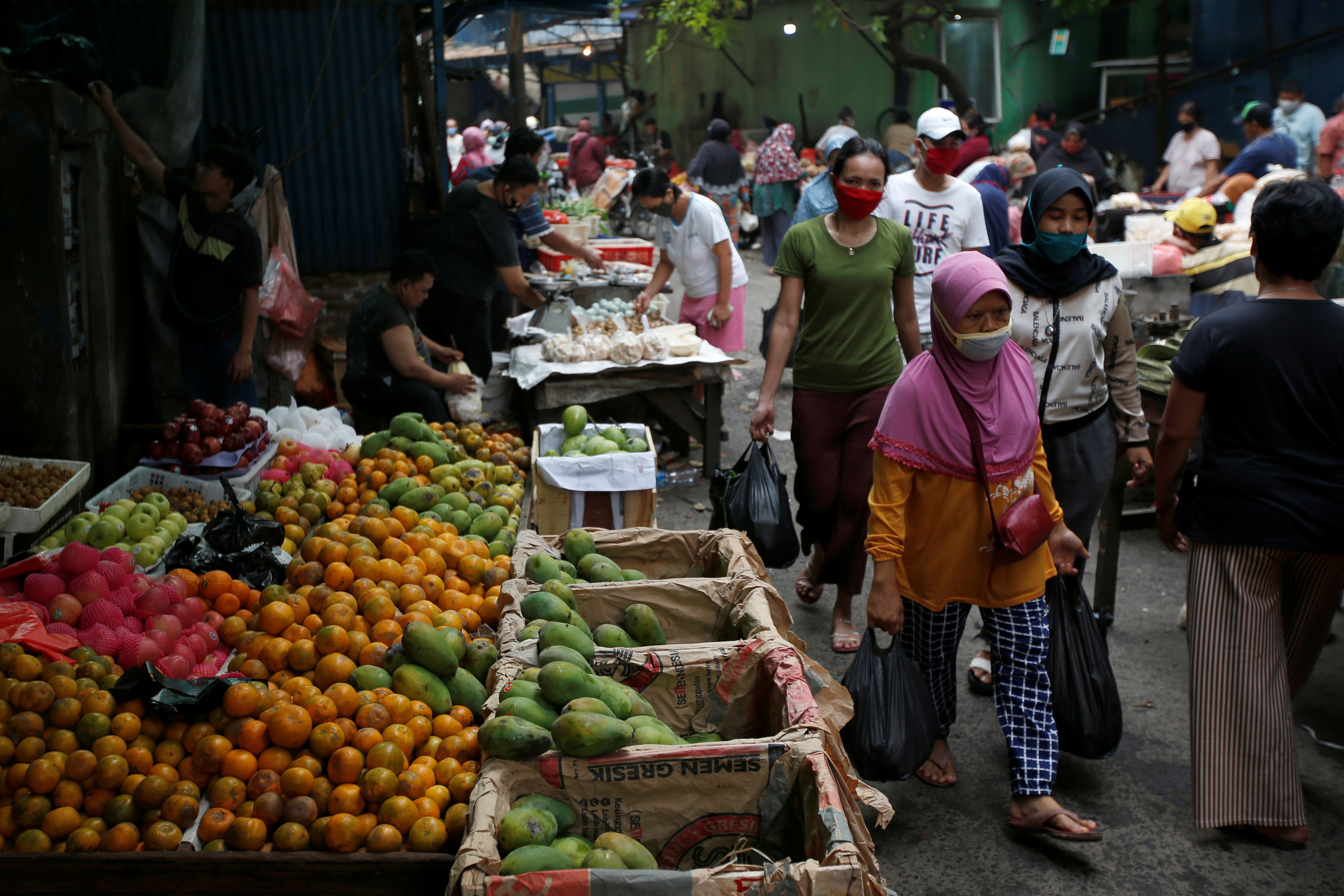 People shop at a market in Jakarta. Indonesia’s informal sector makes up between 60 and 70 per cent of the economy, and is where the country’s most vulnerable make their living. Photo: Reuters