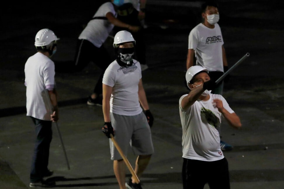 Men in white T-shirts with poles seen in Yuen Long after attacking anti-extradition bill demonstrators at a railway station. Photo: Reuters