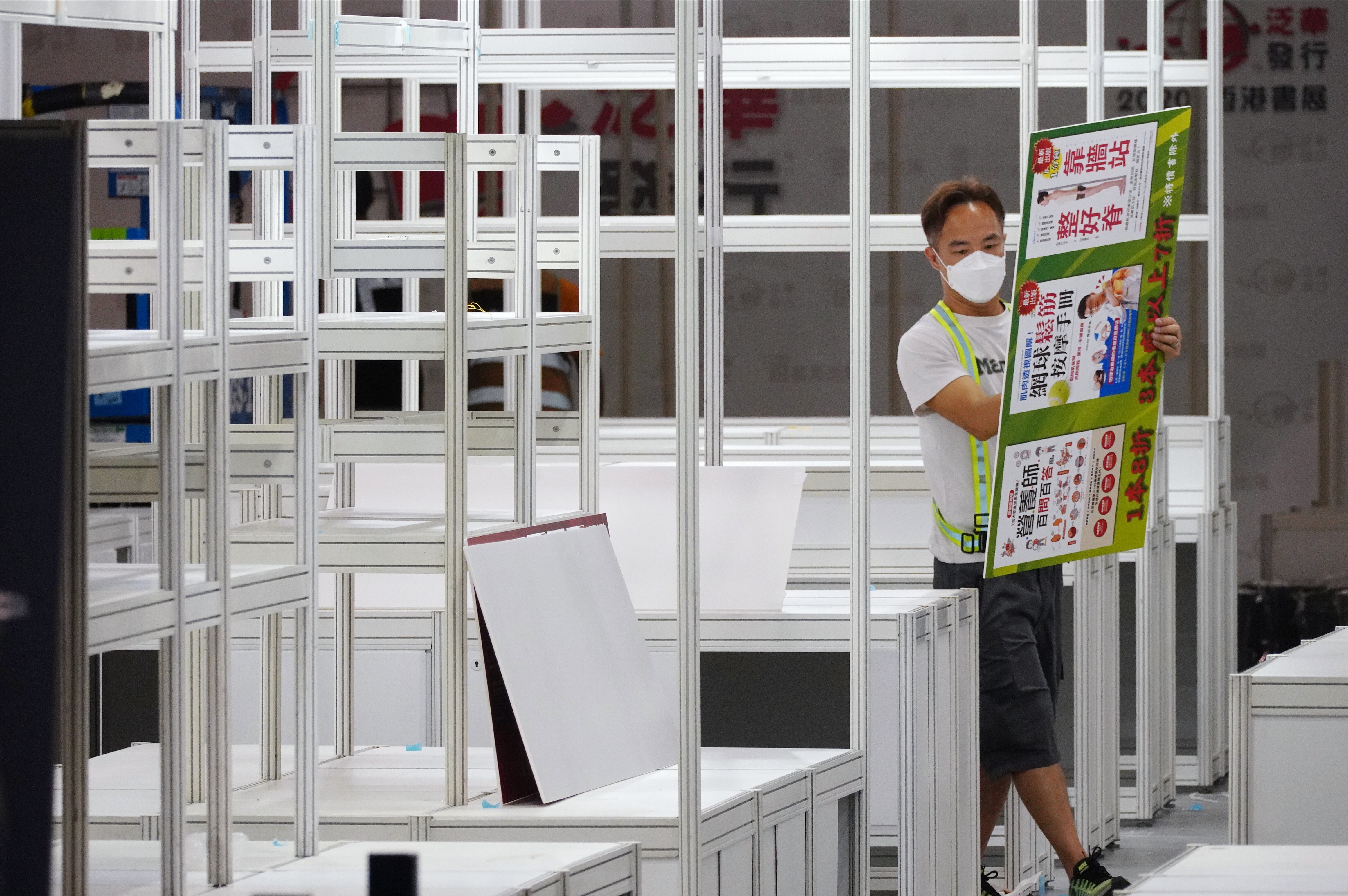A worker takes down a booth after the Hong Kong Book Fair was cancelled. Photo: Sam Tsang
