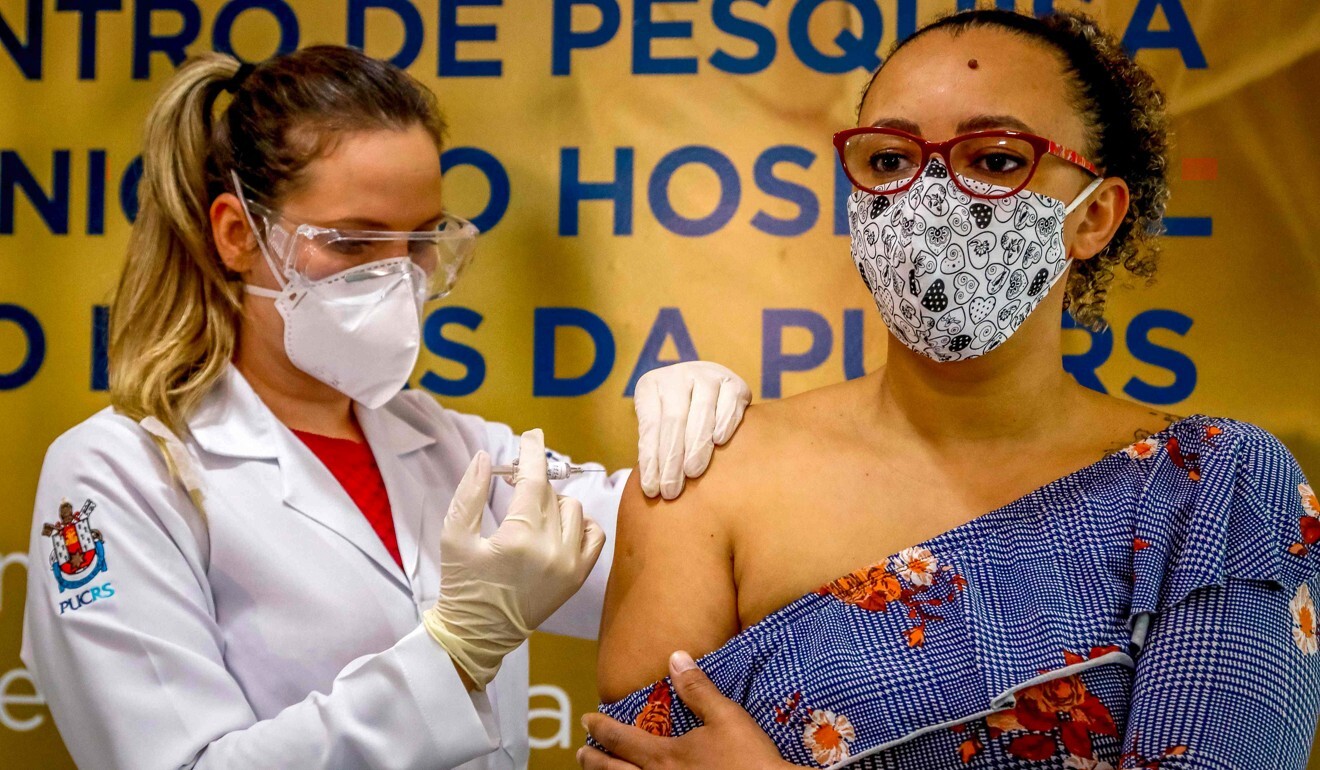 A woman receives a Covid-19 vaccine made by China’s Sinovac during a trial in Brazil. Photo: AFP