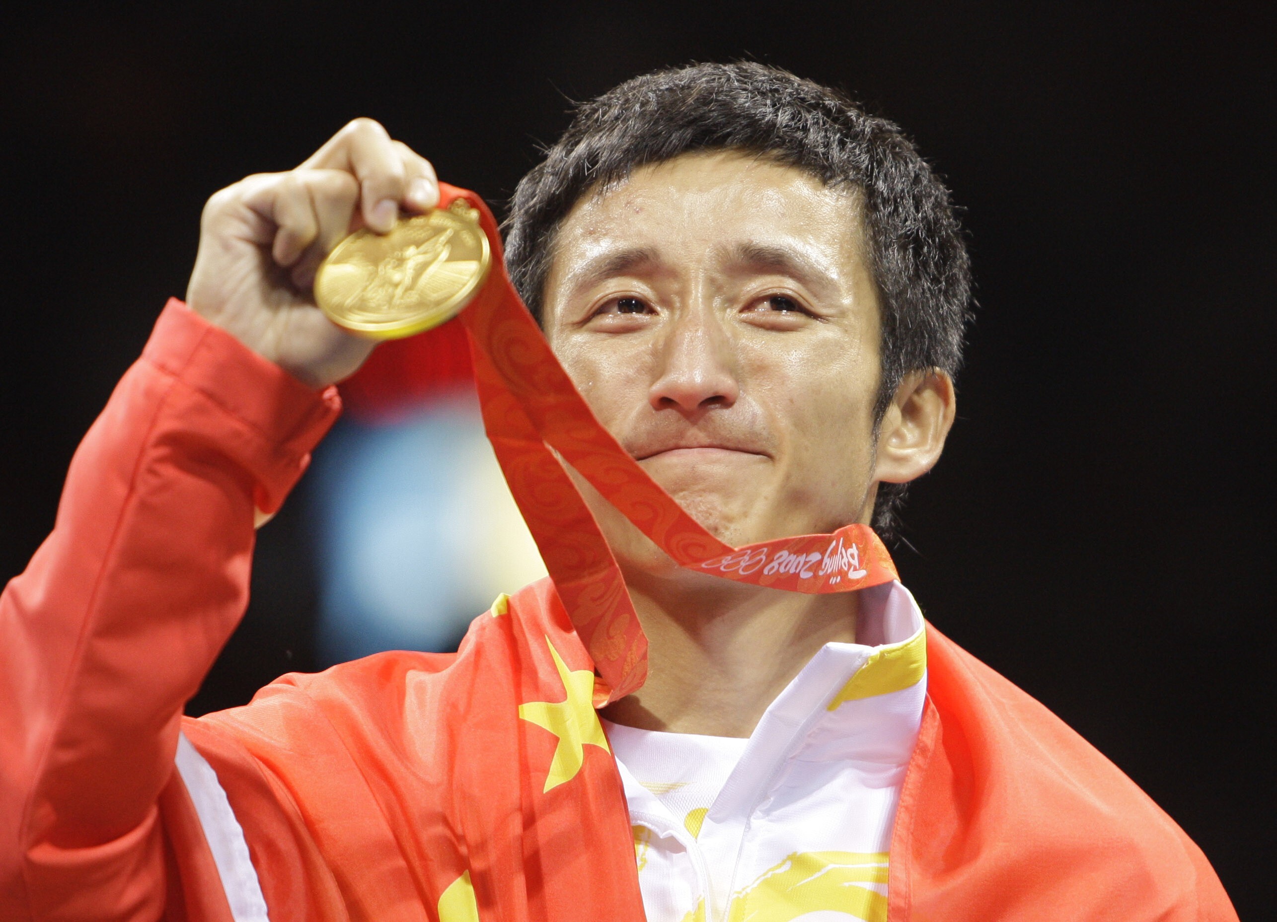 Zou Shiming of China displays his gold medal after defeating Serdamba Purevdorj of Mongolia during the men’s light flyweight final at the Beijing 2008 Olympics. Photo: AP