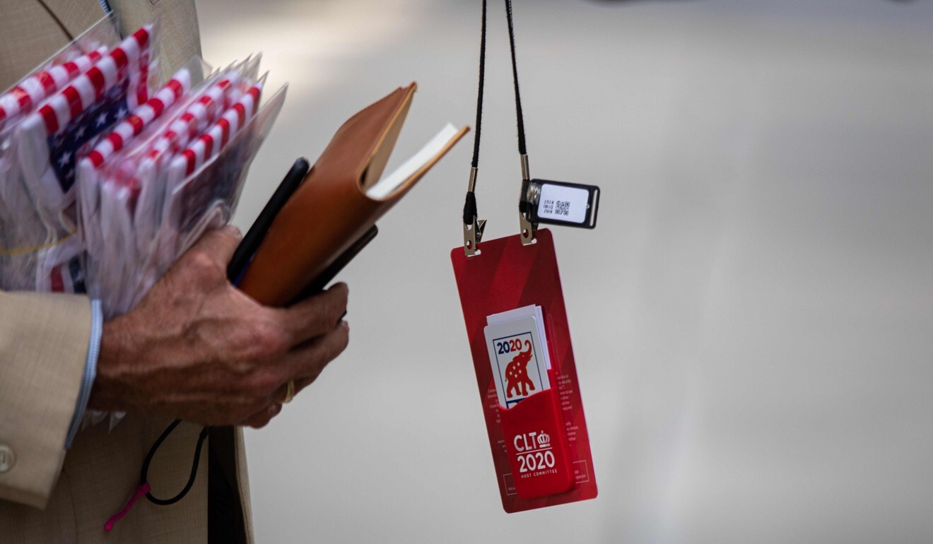 A bluetooth tracking device can be seen hanging off a convention delegate's official credential before he enters the Charlotte Convention Centre in Charlotte, North Carolina, on Sunday. Photo: AFP