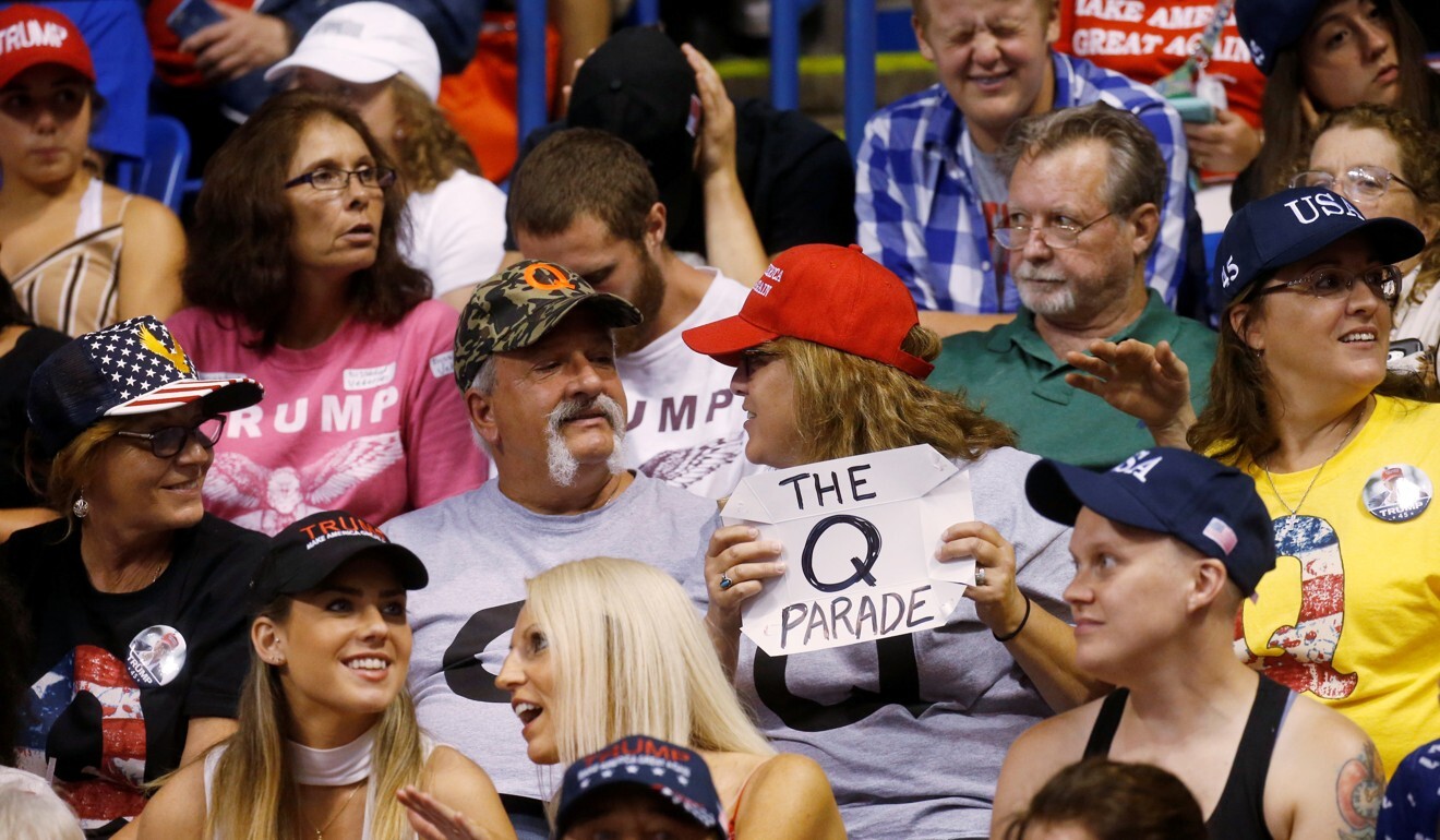 A supporter holds a QAnon sign as US President Donald Trump addresses a campaign rally in Wilkes-Barre, Pennsylvania. Photo: Reuters