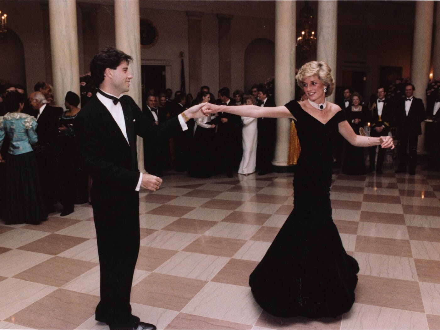 Diana, wearing a favourite pearl and sapphire choker, dances with John Travolta at a White House dinner in Washington in 1985. Photo: AP