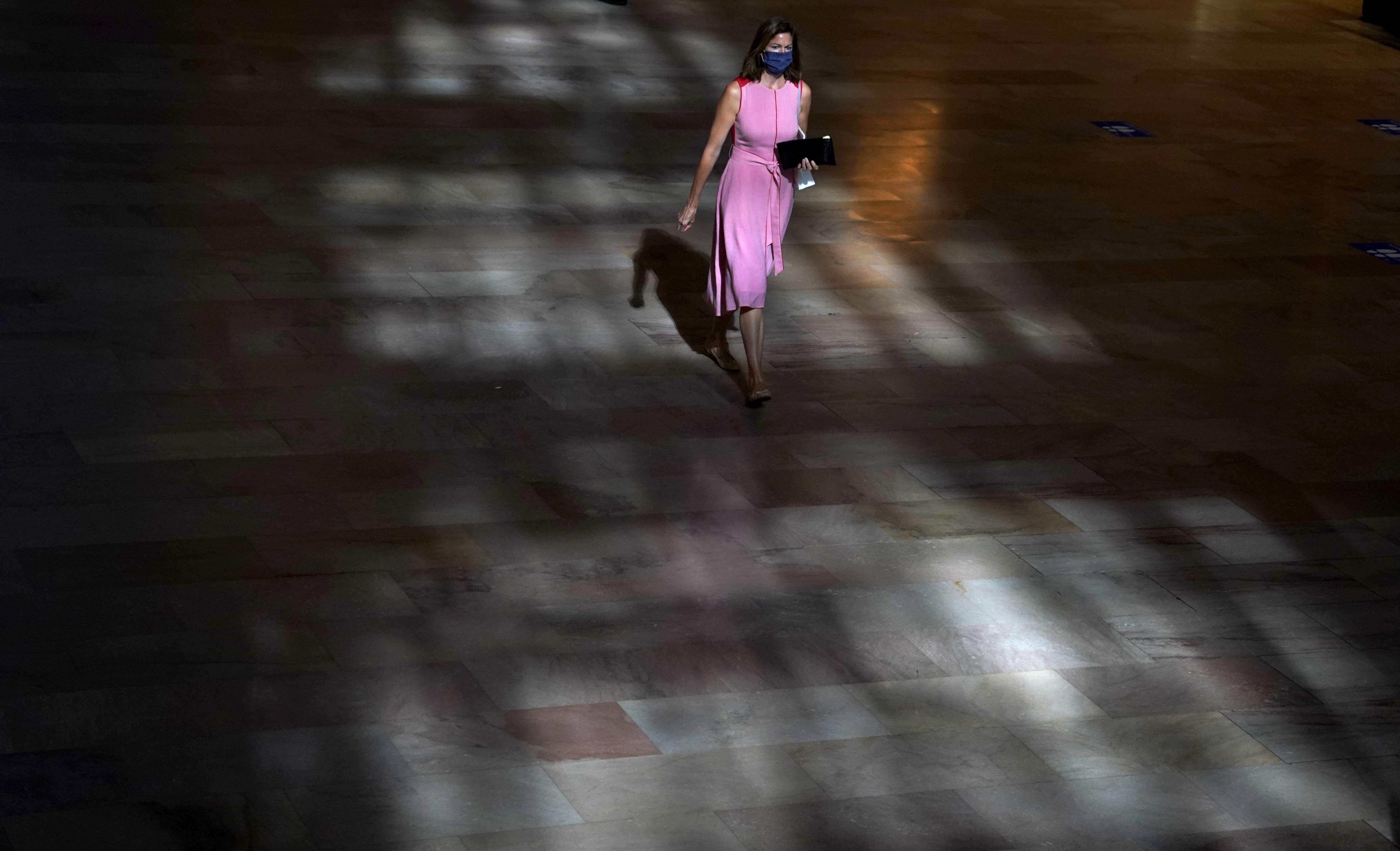 A woman walks through Grand Central Terminal in New York on August 24. America’s abysmal failure to contain the virus not only underscores the lingering fears of infection, but also raises the distinct possibility of a new wave of Covid-19 itself. Photo: AFP