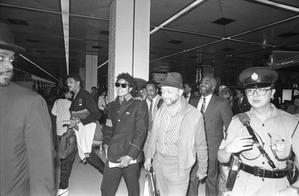 Pop superstar Michael Jackson at Kai Tak Airport with his entourage of bodyguards, before flying to Sydney. Photo: SCMP