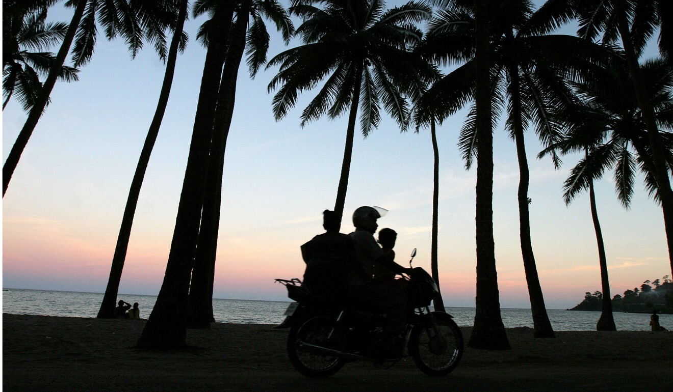 A motorist drives along the seashore with his family in Port Blair, in India’s Andaman and Nicobar Islands archipelago. Photo: AP