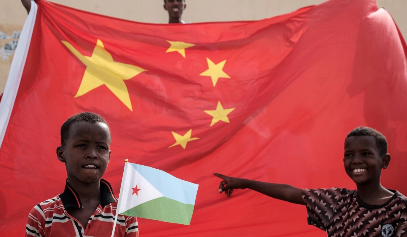 Two boys with the flags of Djibouti and China. Photo: AFP
