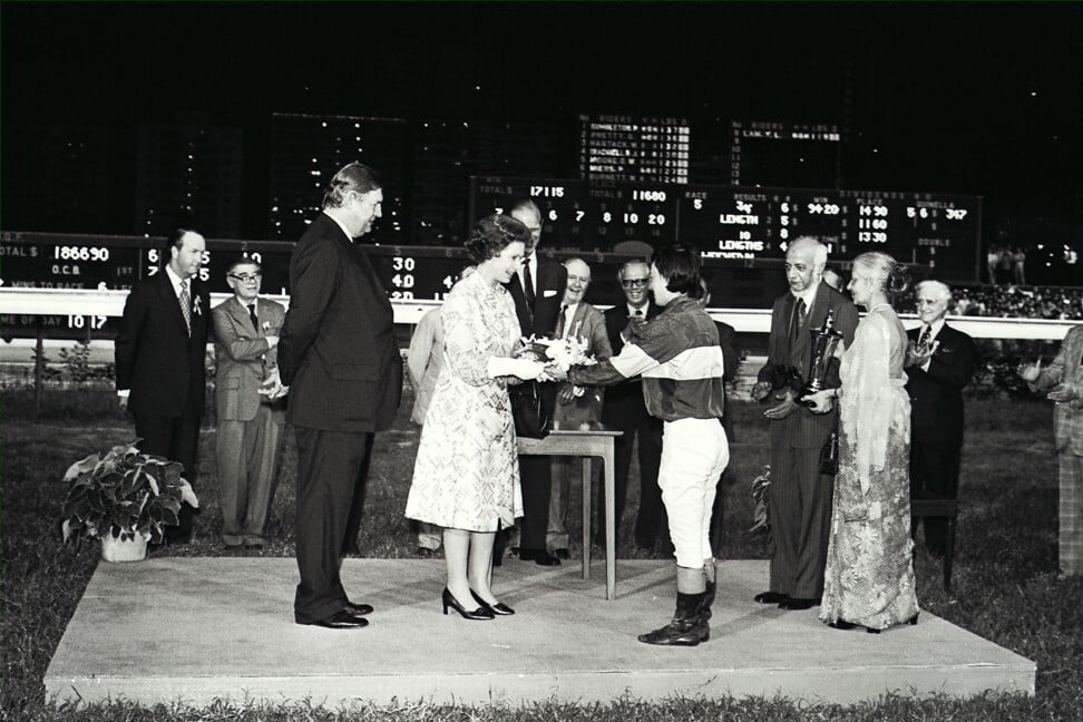 Winning jockey Peter Cheam presents a bouquet to Queen Elizabeth at the Happy Valley Racecourse. Photo: SCMP