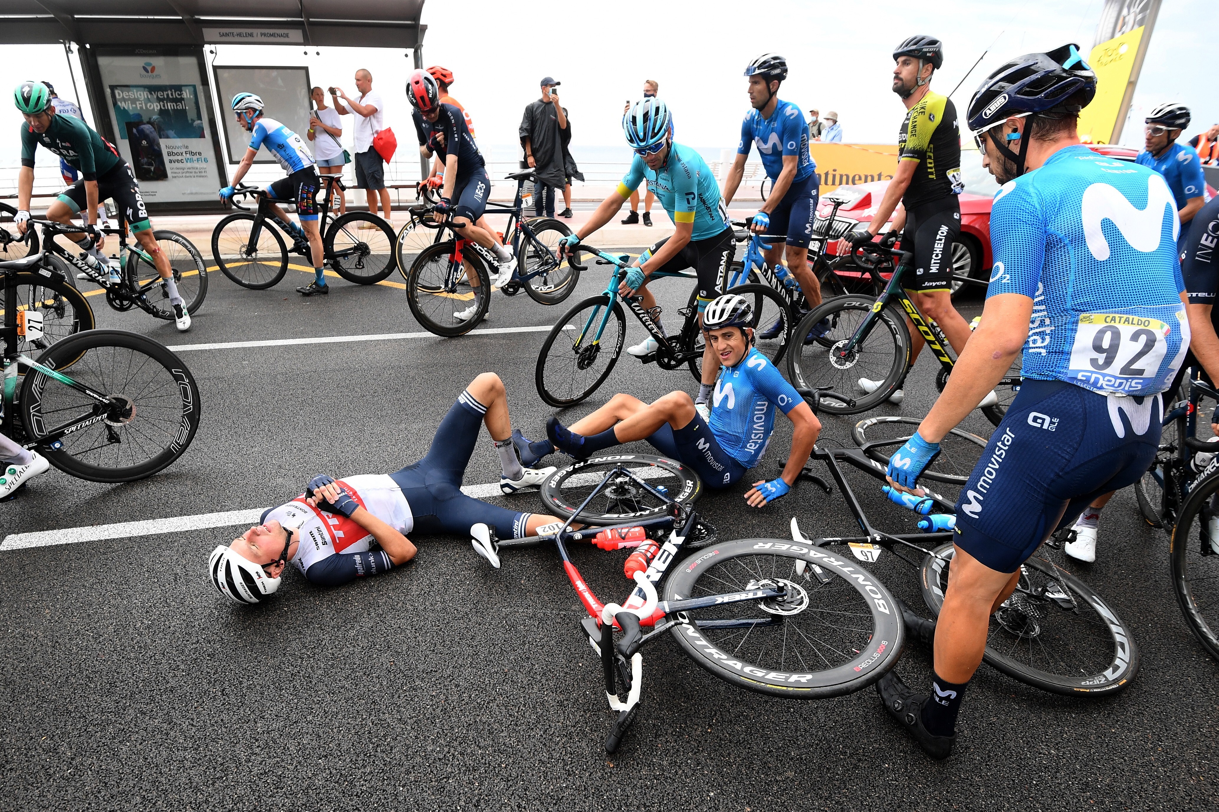 Danish rider Niklas Eg (left) of Trek-Segafredo team and Spanish rider Marc Soler (right) of Movistar Team lie on the road, one of many crashes during stage one of the Tour de France. Photo: EPA