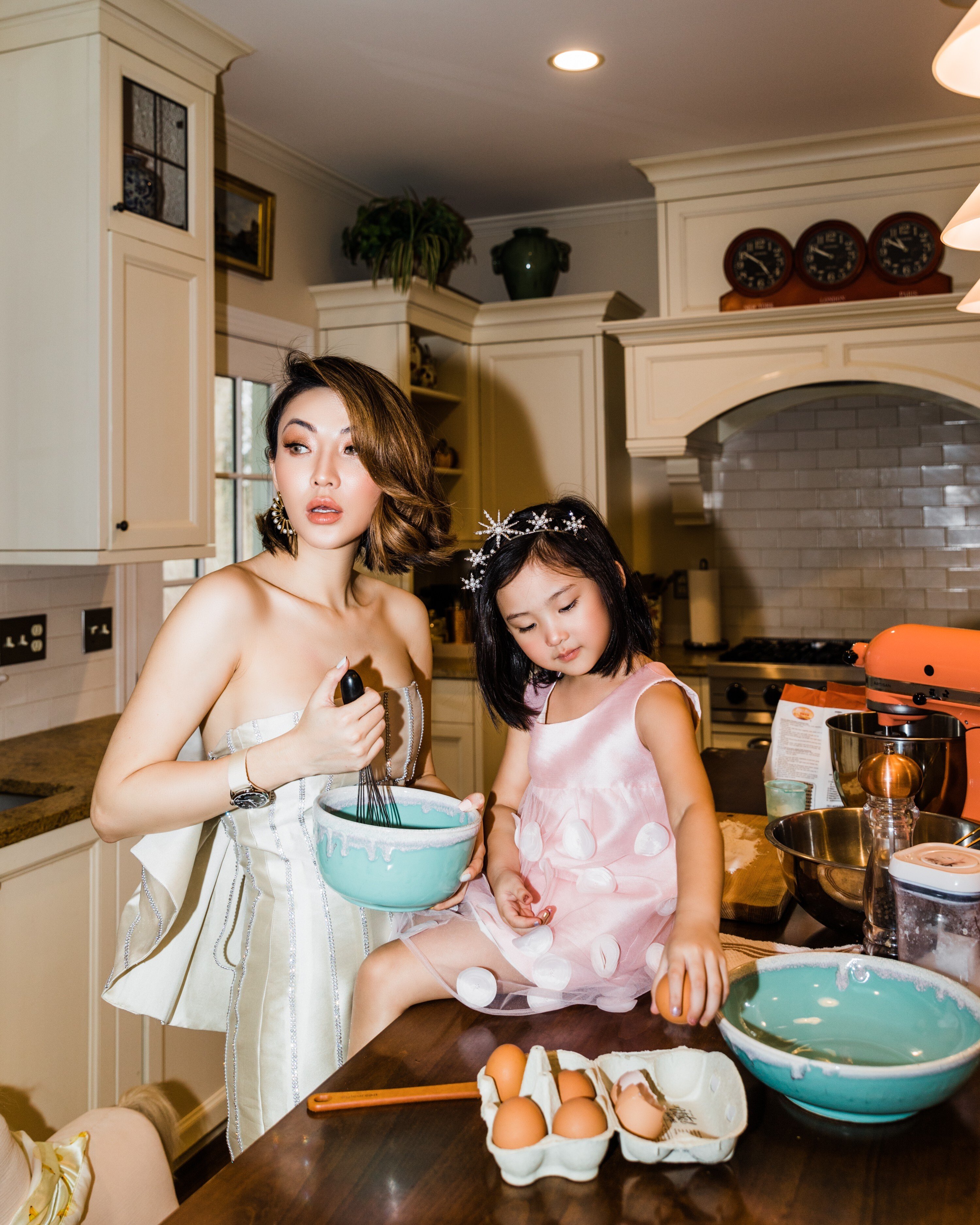 A dressed up Jessica Wang in the kitchen at home with her daughter.