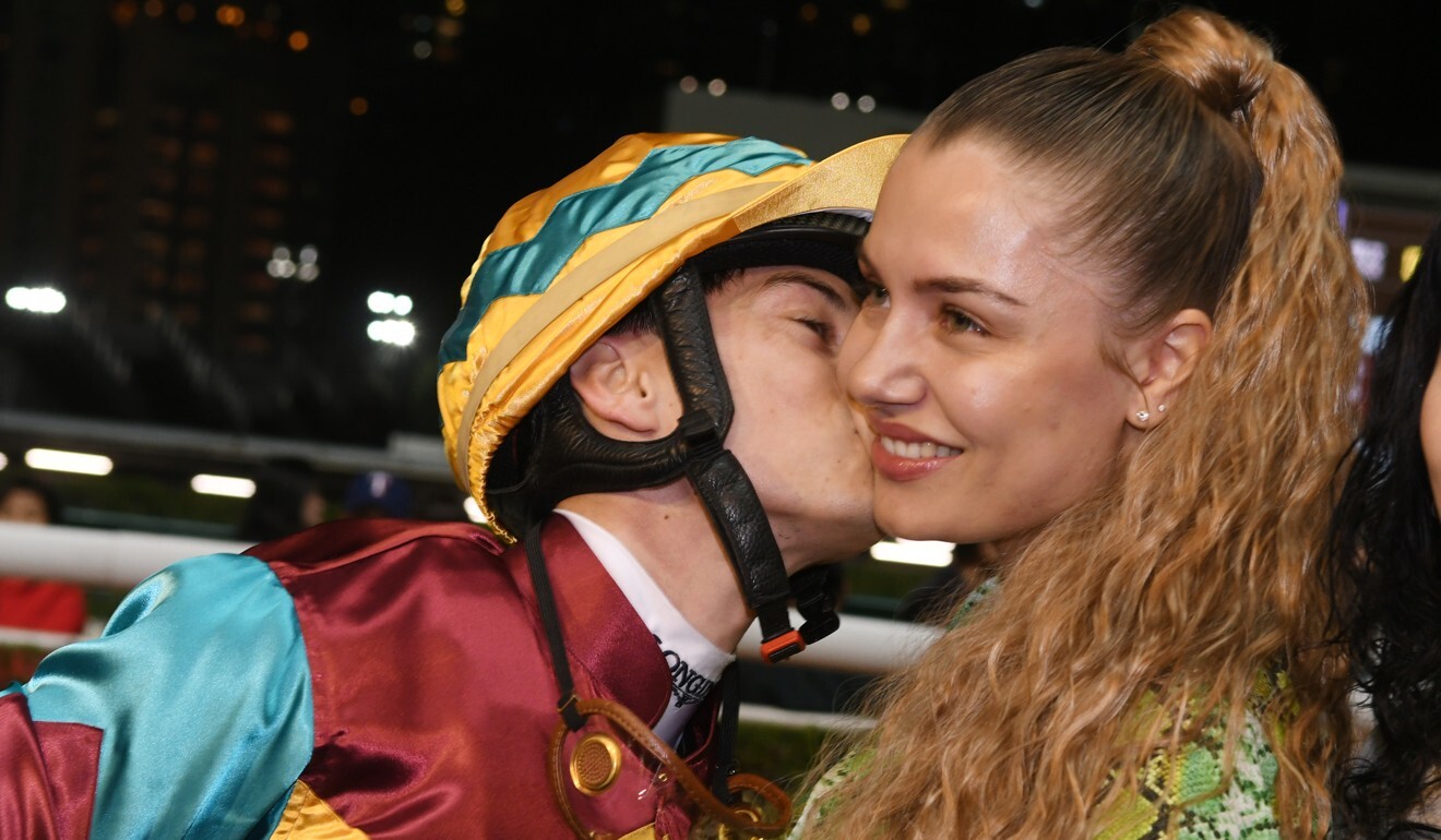 Jockey Alexis Badel kisses wife Eva after winning a race at Happy Valley.