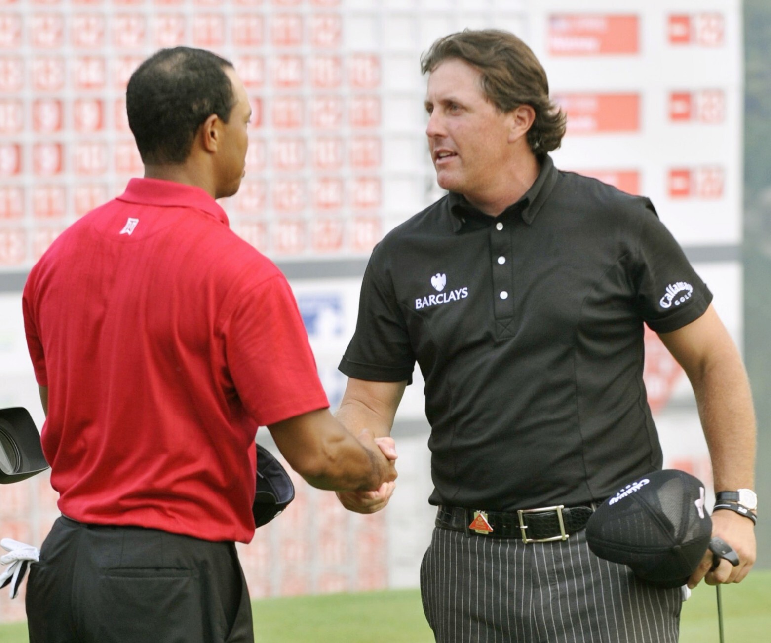 Phil Mickelson is congratulated by Tiger Woods after winning the WGC-HSBC Champions in Shanghai in 2009. The 2020 event has been cancelled due to the coronavirus. Photo: Kyodo