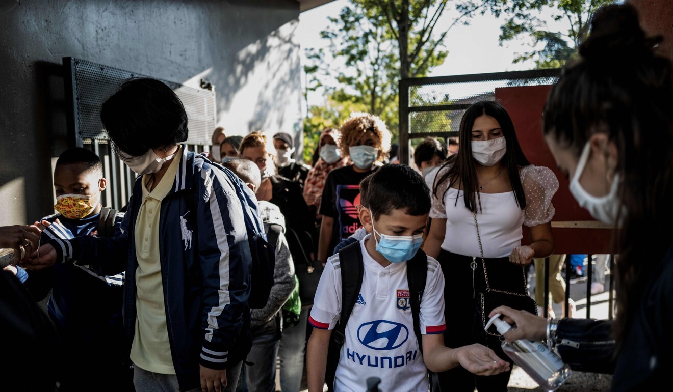 Pupils wearing protective masks arrive at a middle school in Bron. Photo: AFP