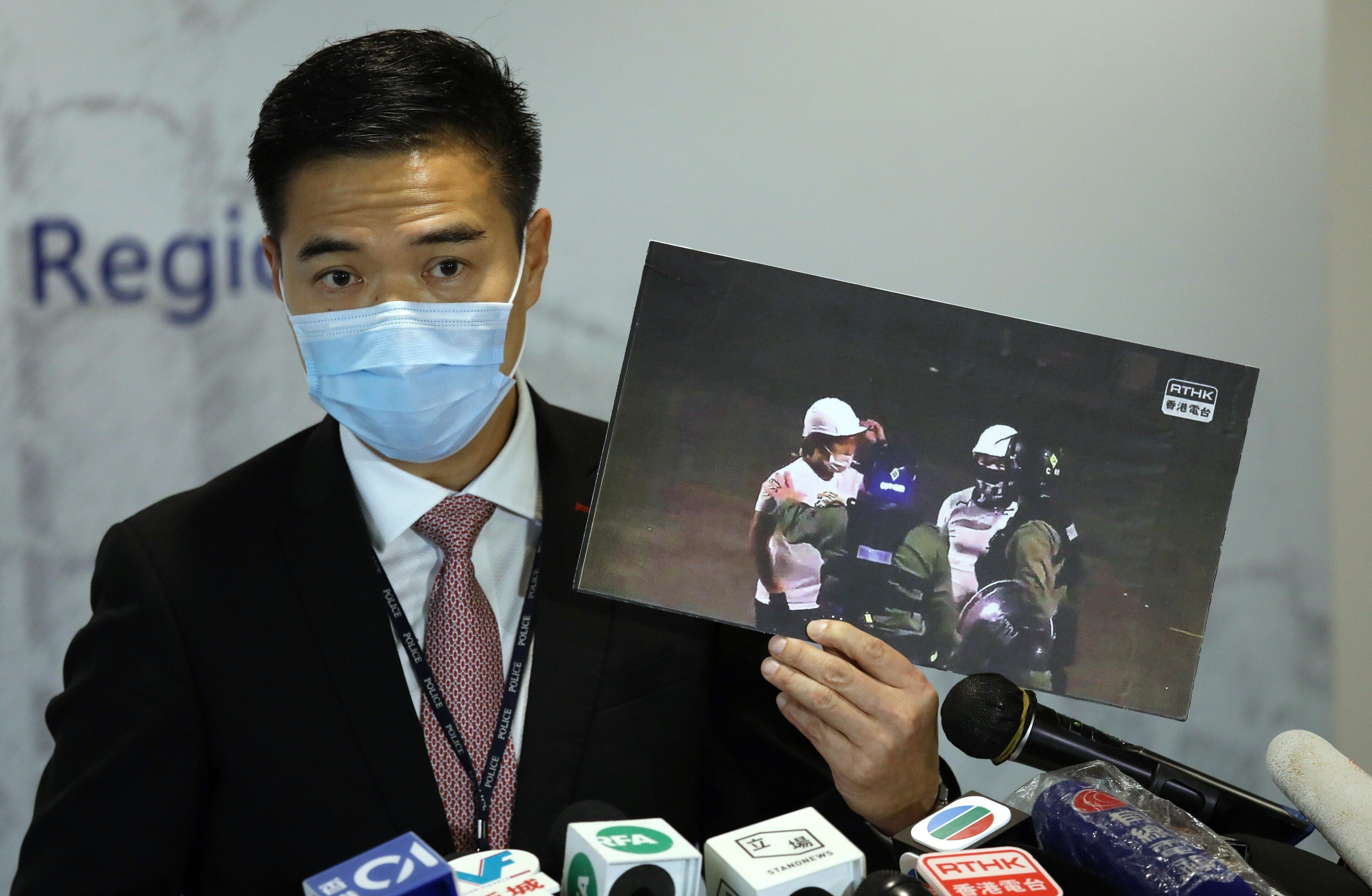 Police senior superintendent Chan Tin-chu holds up a photo from the night of the Yuen Long attack on July 21, 2019, during a press conference on August 26. Photo: Nora Tam