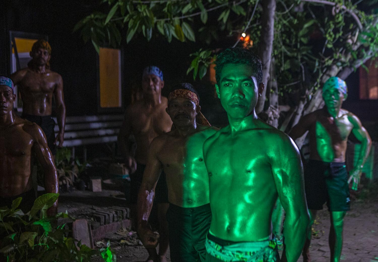 Bodybuilding contestants wait their turn to show their moves. Photo: Agoes Rudianto