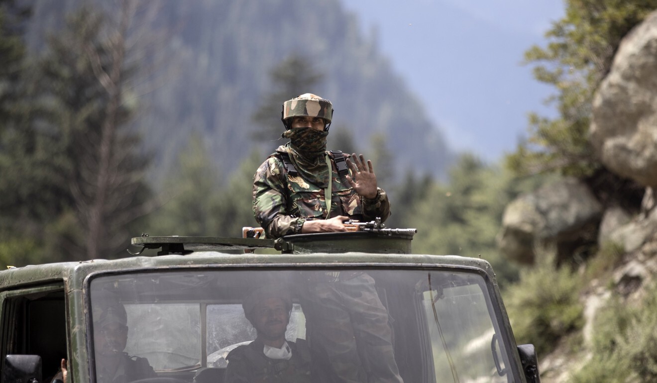 An Indian army soldier keeps guard on top of his vehicle as their convoy moves near the country’s disputed border with China earlier this month. Photo: AP