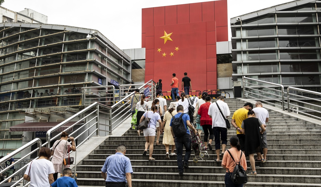 People walk up steps at a border crossing facility in the Sha Tou Jiao Port of Shenzhen. Photo: Qilai Shen/Bloomberg