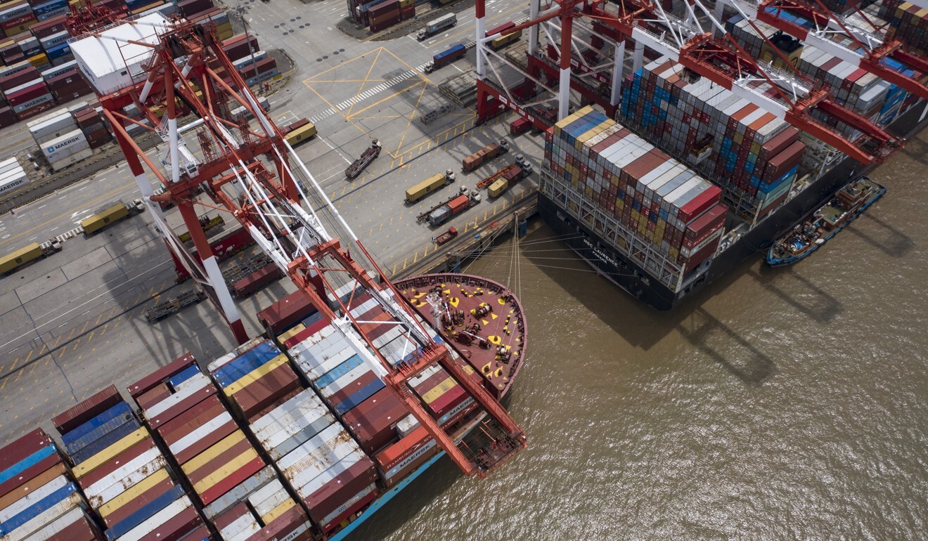 Vessels loaded with shipping containers are docked at the Yangshan Deepwater Port in Shanghai on July 12. Cargo sent to Europe by rail would arrive much quicker than that sent by sea. Photo: Bloomberg