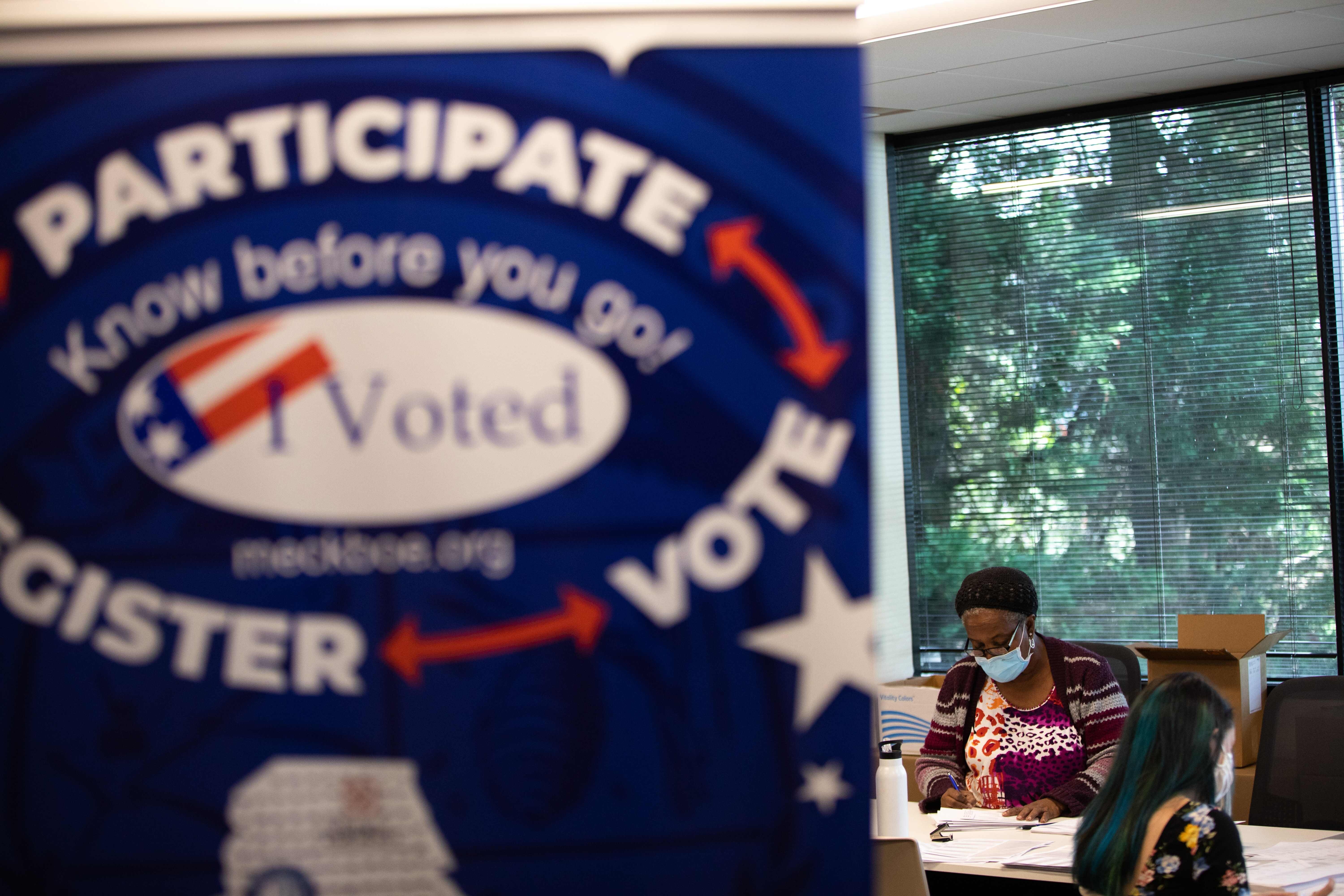 Postal vote election workers stuff applications at the Mecklenburg County Board of Elections office in Charlotte, North Carolina. Photo: AFP