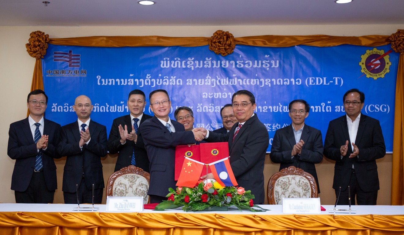 Representatives from China Southern Power Grid and Electricite du Laos shake hands during a signing ceremony in Vientiane, Laos, on Tuesday. Photo: Xinhua
