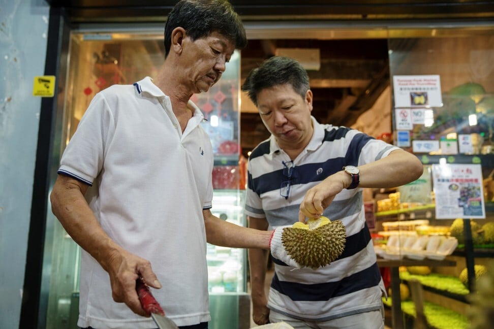 A customer samples durians at a durian store in Singapore. Photo: AFP