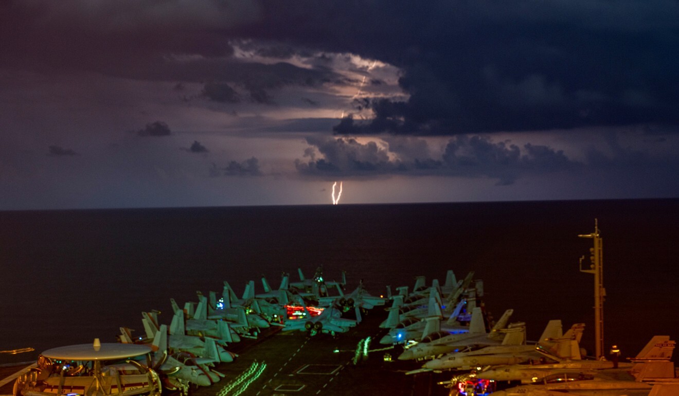 Lightning flashes over the US Navy aircraft carrier USS Nimitz as it transits the South China Sea in July 2020. Photo: Reuters