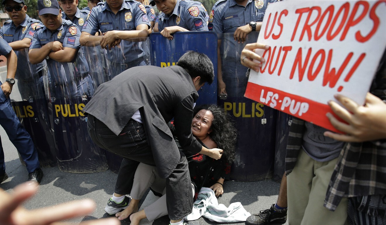 Protesters re-enact a fight between the Filipino transgender woman Jennifer Laude and US Marine Joseph Scott Pemberton outside the US embassy in Manila. Photo: AP