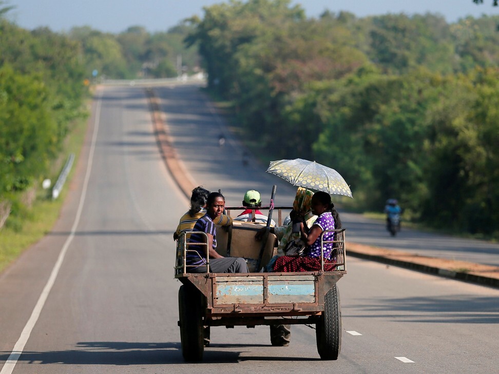 Villagers travel in a tractor on a newly built road in Hambantota, where a US$1 billion port was built with Chinese loans. Photo: Reuters