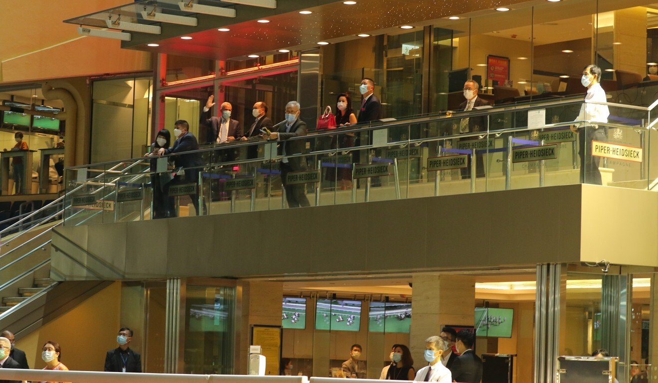 Some owners with starters watch their horses run in the opening race at Happy Valley on Wednesday night.