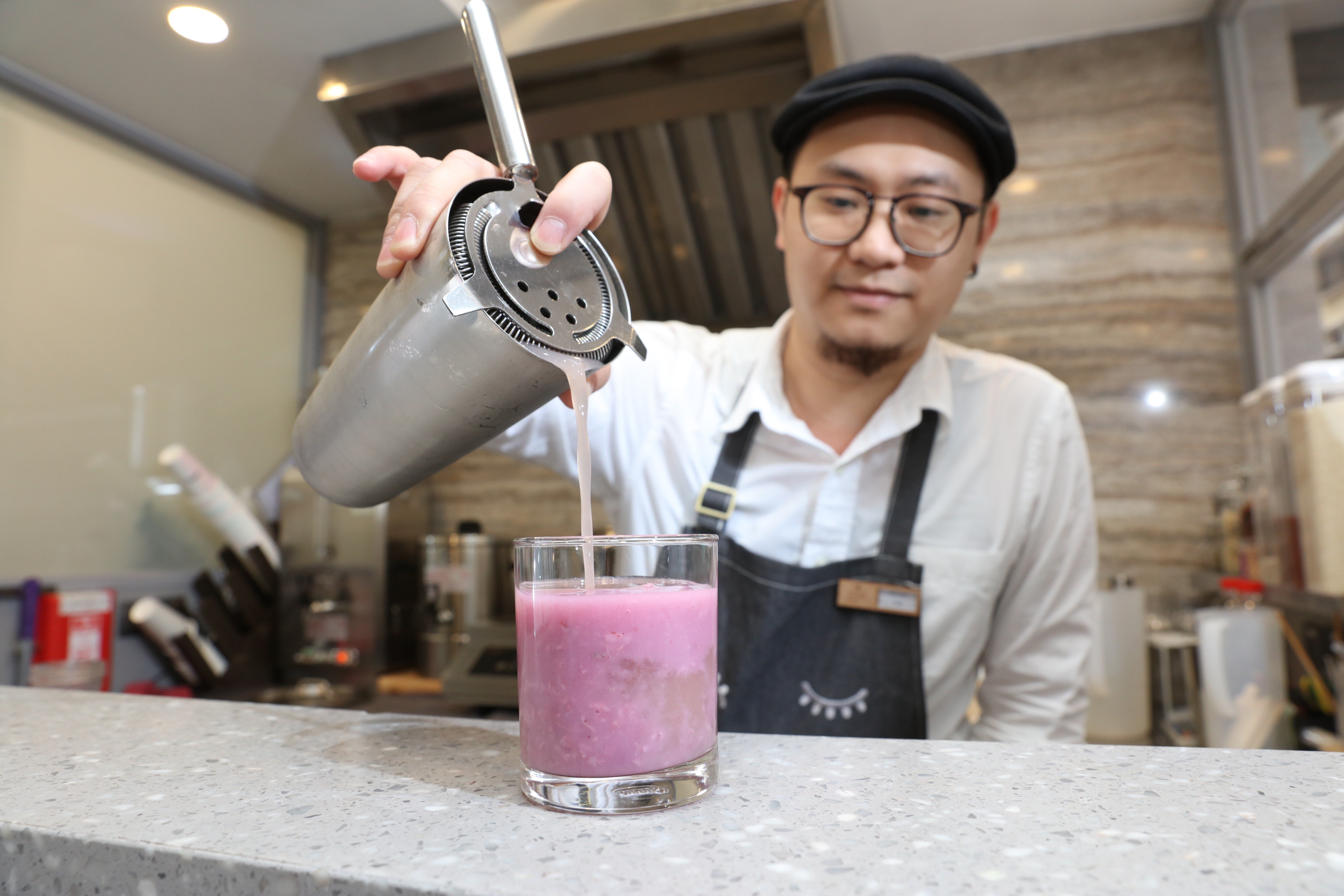 A mixologist prepares a mocktail of purple sweet potato and oats rice water in the Sheung Wan store of CheckCheckCin, which is promoting a modern approach to traditional Chinese medicine among Hong Kong’s younger consumers. Photo: Felix Wong