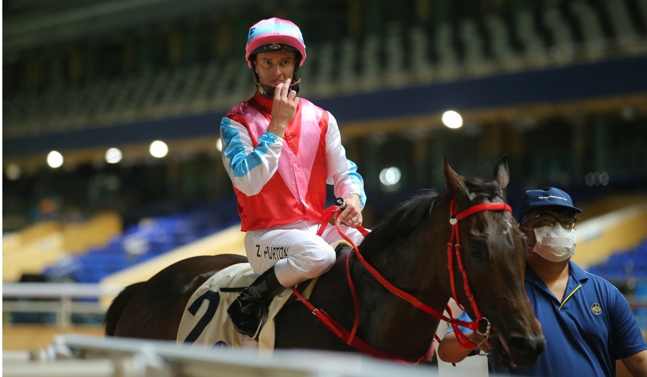 Zac Purton returns to scale in front of empty stands at Happy Valley after winning on Harmony N Home.