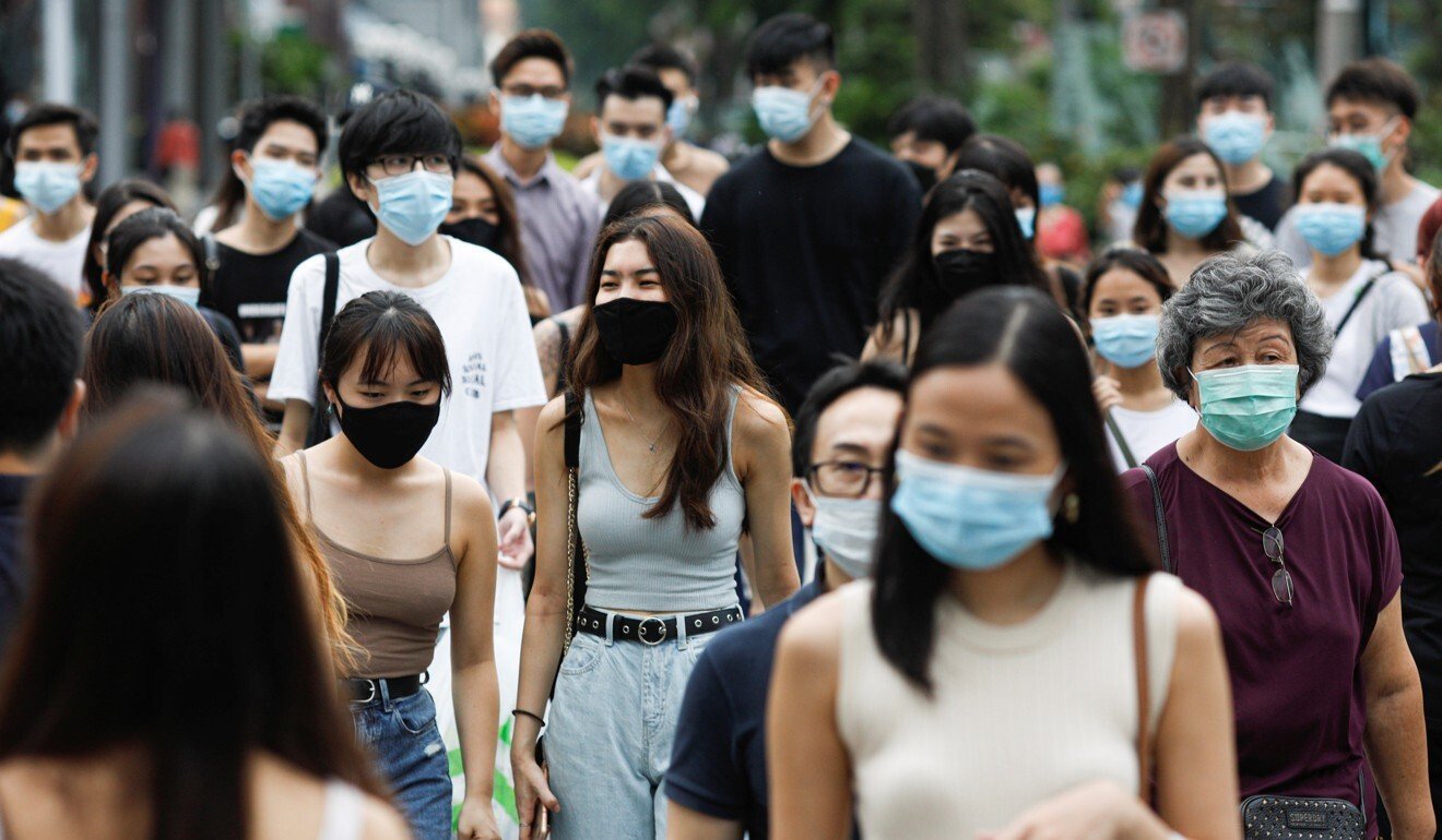 People cross a street in the shopping district of Orchard Road, Singapore. Photo: Reuters