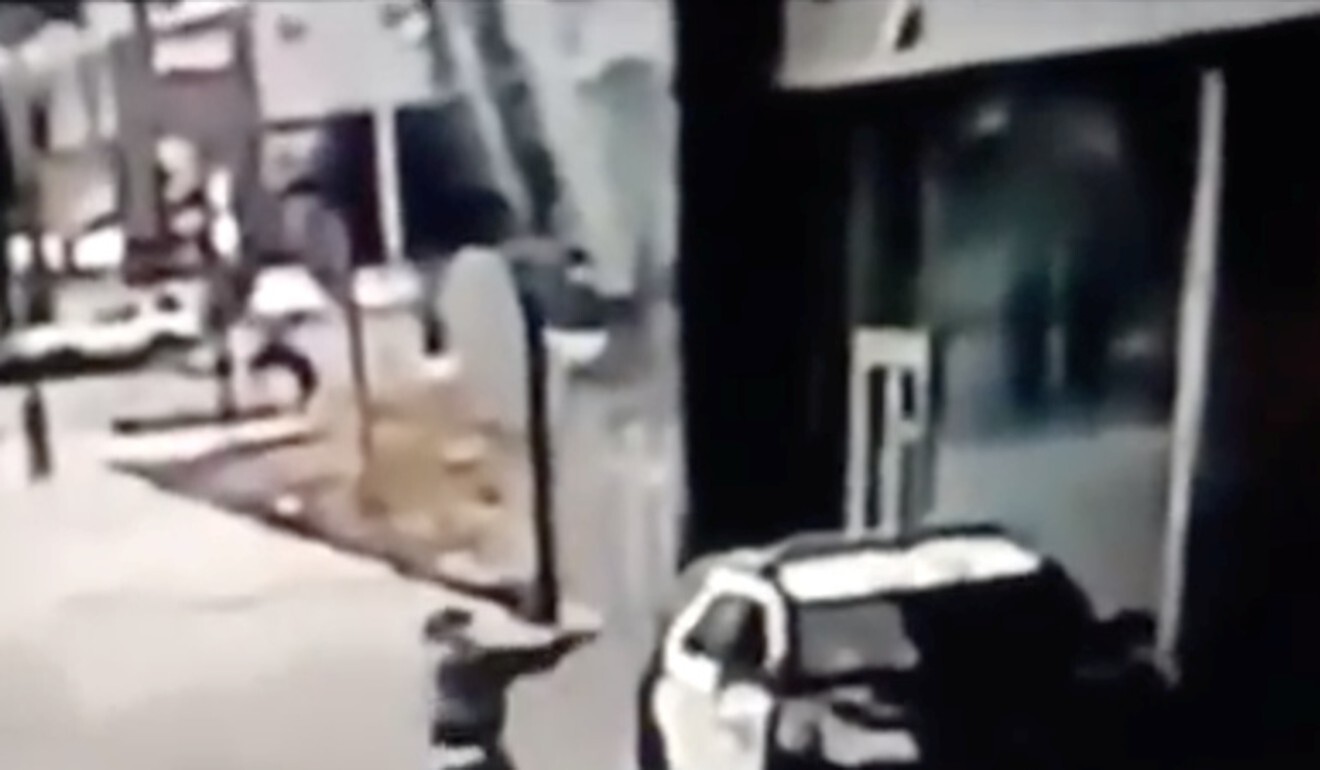 A man aims at a police vehicle in Compton, California, US on September 13, 2020 in this still image taken from a video tweeted by the Los Angeles Sheriff’s Department. Photo: Los Angeles County Sheriff’s Department via Reuters