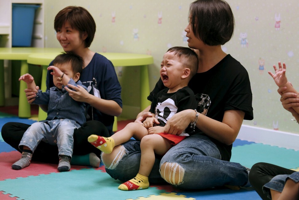 A child cries in the arms of his mother as they take part in a class preparing toddlers for kindergarten interviews in Hong Kong in 2015. Photo: Reuters